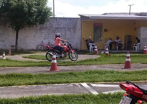Student riding a training motorcycle on the practice course