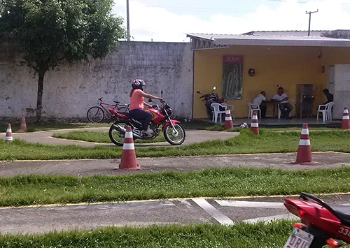 Student riding a training motorcycle on the practice course